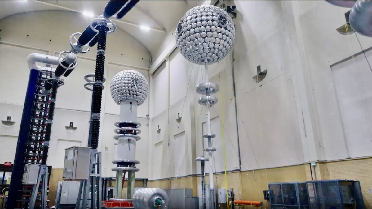 High-voltage testing equipment and large spherical capacitors inside a power-grid laboratory.