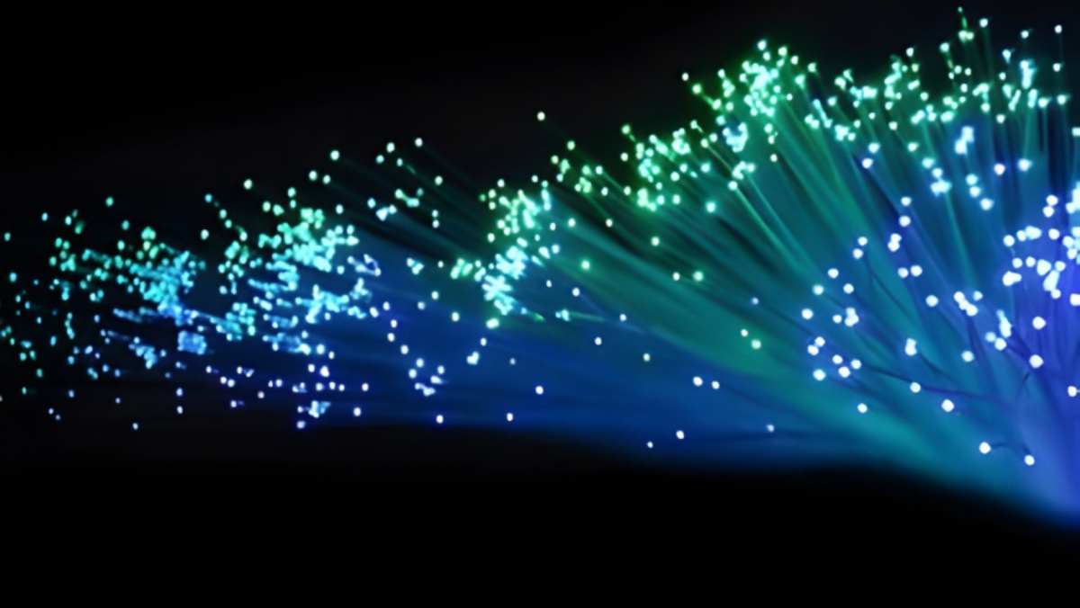 Green and blue fiber-optic strands glowing to represent fast digital grid signals.