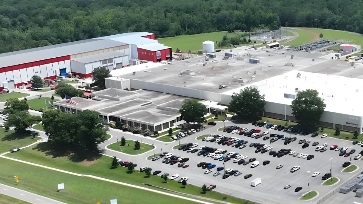 Modern transformer manufacturing campus with clustered facilities and surrounding green space